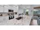 Modern kitchen with white cabinets, granite countertops, and stainless steel appliances at 6650 Cheswick St, Sarasota, FL 34243