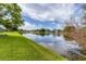 Serene lake view with lush green landscaping at 6650 Cheswick St, Sarasota, FL 34243