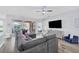 Spacious living area with a sectional sofa, hardwood floors, and a view to the bedroom at 6650 Cheswick St, Sarasota, FL 34243
