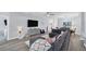 Living room with sectional sofa, hardwood floors, and dining area view at 6650 Cheswick St, Sarasota, FL 34243