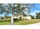 Single-story house with a large tree in the front yard, and a neatly landscaped lawn at 676 Planters Manor Way, Bradenton, FL 34212