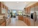 Open concept kitchen with breakfast bar overlooking the pool and golf course at 676 Planters Manor Way, Bradenton, FL 34212