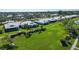 An aerial view of a community with single story homes and lush green spaces at 6810 9Th W Ave, Bradenton, FL 34209