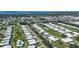 Aerial view of a community with many houses, pools, and lush landscaping at 6810 9Th W Ave, Bradenton, FL 34209