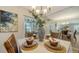 Bright dining room with table set for four and view to backyard at 6810 9Th W Ave, Bradenton, FL 34209