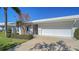 Condo exterior showcasing a neatly landscaped front yard and a double-car garage at 6810 9Th W Ave, Bradenton, FL 34209