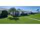 White single story home with a well-manicured lawn and palm trees at 6810 9Th W Ave, Bradenton, FL 34209