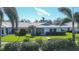 Back view of a single story home with a screened porch and a landscaped yard at 6810 9Th W Ave, Bradenton, FL 34209