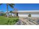 View of a home's front with a two car garage and well-maintained lawn at 6810 9Th W Ave, Bradenton, FL 34209