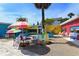 Bright and colorful shopping plaza with outdoor seating at 6810 9Th W Ave, Bradenton, FL 34209