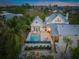 Aerial view of a two-story house with a pool and patio at 689 Lands End Dr, Longboat Key, FL 34228