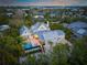 Aerial view of a charming house, pool, and surrounding landscape at 689 Lands End Dr, Longboat Key, FL 34228