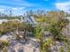 Aerial view of a house with lush landscaping and a spacious yard at 689 Lands End Dr, Longboat Key, FL 34228