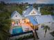 Aerial view of a two-story house with a pool and patio at 689 Lands End Dr, Longboat Key, FL 34228