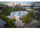 Stunning aerial view of a charming waterfront home with a private pool at 689 Lands End Dr, Longboat Key, FL 34228