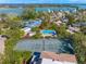 Aerial showing a tennis court and swimming pool in a tropical setting at 689 Lands End Dr, Longboat Key, FL 34228