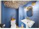 Charming powder room with blue walls and a pedestal sink at 689 Lands End Dr, Longboat Key, FL 34228