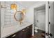 Modern bathroom with dark vanity and a white-tiled backsplash at 689 Lands End Dr, Longboat Key, FL 34228