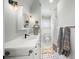 Clean bathroom with white vanity, black and white floor, and shower at 689 Lands End Dr, Longboat Key, FL 34228