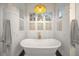 Spa-like bathroom with freestanding tub, gold fixtures, and white shiplap walls at 689 Lands End Dr, Longboat Key, FL 34228