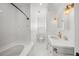 Clean bathroom with white tile, a bathtub, and a pedestal sink at 689 Lands End Dr, Longboat Key, FL 34228