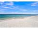 Scenic view of a pristine beach with clear water under a bright sky at 689 Lands End Dr, Longboat Key, FL 34228