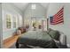 Serene bedroom with wood floors, a green duvet, and access to a balcony at 689 Lands End Dr, Longboat Key, FL 34228