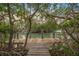 Wooden dock extending over calm water, offering waterfront access at 689 Lands End Dr, Longboat Key, FL 34228