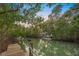 Wooden dock with rope railings alongside a tranquil waterway at 689 Lands End Dr, Longboat Key, FL 34228