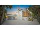 Two-story white house with gray double doors and a screened porch at 689 Lands End Dr, Longboat Key, FL 34228