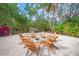 Cozy fire pit area with wooden chairs at 689 Lands End Dr, Longboat Key, FL 34228