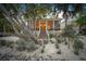 Home's exterior at dusk showcasing landscaping and porch at 689 Lands End Dr, Longboat Key, FL 34228
