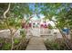 Charming front yard with a white picket fence and a wooden walkway at 689 Lands End Dr, Longboat Key, FL 34228