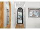 Hallway with wood floors, arched doorway, and large framed print at 689 Lands End Dr, Longboat Key, FL 34228