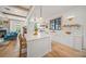 White kitchen with marble island, herringbone tile, and stainless steel appliances at 689 Lands End Dr, Longboat Key, FL 34228