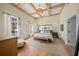 Spacious main bedroom with hardwood floors, exposed beams, and access to pool at 689 Lands End Dr, Longboat Key, FL 34228