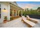 Charming patio with rocking chairs and lounge chairs at 689 Lands End Dr, Longboat Key, FL 34228