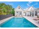Inviting pool with a checkerboard border and a large backyard at 689 Lands End Dr, Longboat Key, FL 34228