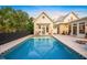 Inviting pool with a checkerboard border and a large backyard at 689 Lands End Dr, Longboat Key, FL 34228