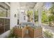 Screened porch features wicker seating and a tranquil view at 689 Lands End Dr, Longboat Key, FL 34228