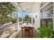 Relaxing screened porch with a dining table and seating area at 689 Lands End Dr, Longboat Key, FL 34228