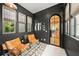 Cozy sitting room with dark walls, two leather armchairs, and a view to kitchen at 689 Lands End Dr, Longboat Key, FL 34228