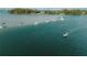 Several boats are anchored in calm water near lush vegetation at 689 Lands End Dr, Longboat Key, FL 34228