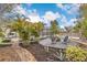 Landscaped backyard with firepit and brick pathway at 7737 40Th E Ct, Sarasota, FL 34243