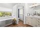 Elegant bathroom with soaking tub, walk-in shower and modern vanity at 7737 40Th E Ct, Sarasota, FL 34243