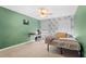 Bedroom with a double bed, desk, and green walls at 7737 40Th E Ct, Sarasota, FL 34243