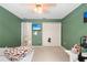 Green-walled bedroom with double bed and large closet at 7737 40Th E Ct, Sarasota, FL 34243