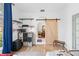 Bedroom with barn door, built-in shelves, and window at 7737 40Th E Ct, Sarasota, FL 34243