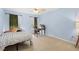 Light blue bedroom with double bed, desk, and window at 7737 40Th E Ct, Sarasota, FL 34243
