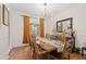 Bright dining room featuring a rustic wood table and stylish chandelier at 7737 40Th E Ct, Sarasota, FL 34243